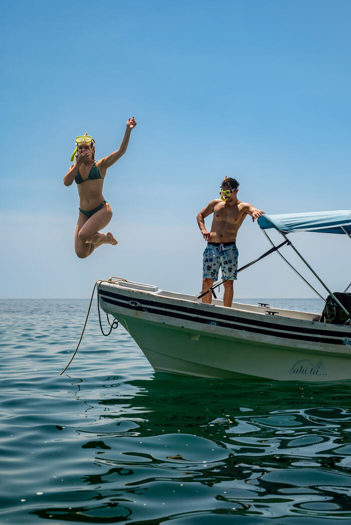 Couple enjoying the ocean off a boat near Playa Caracol